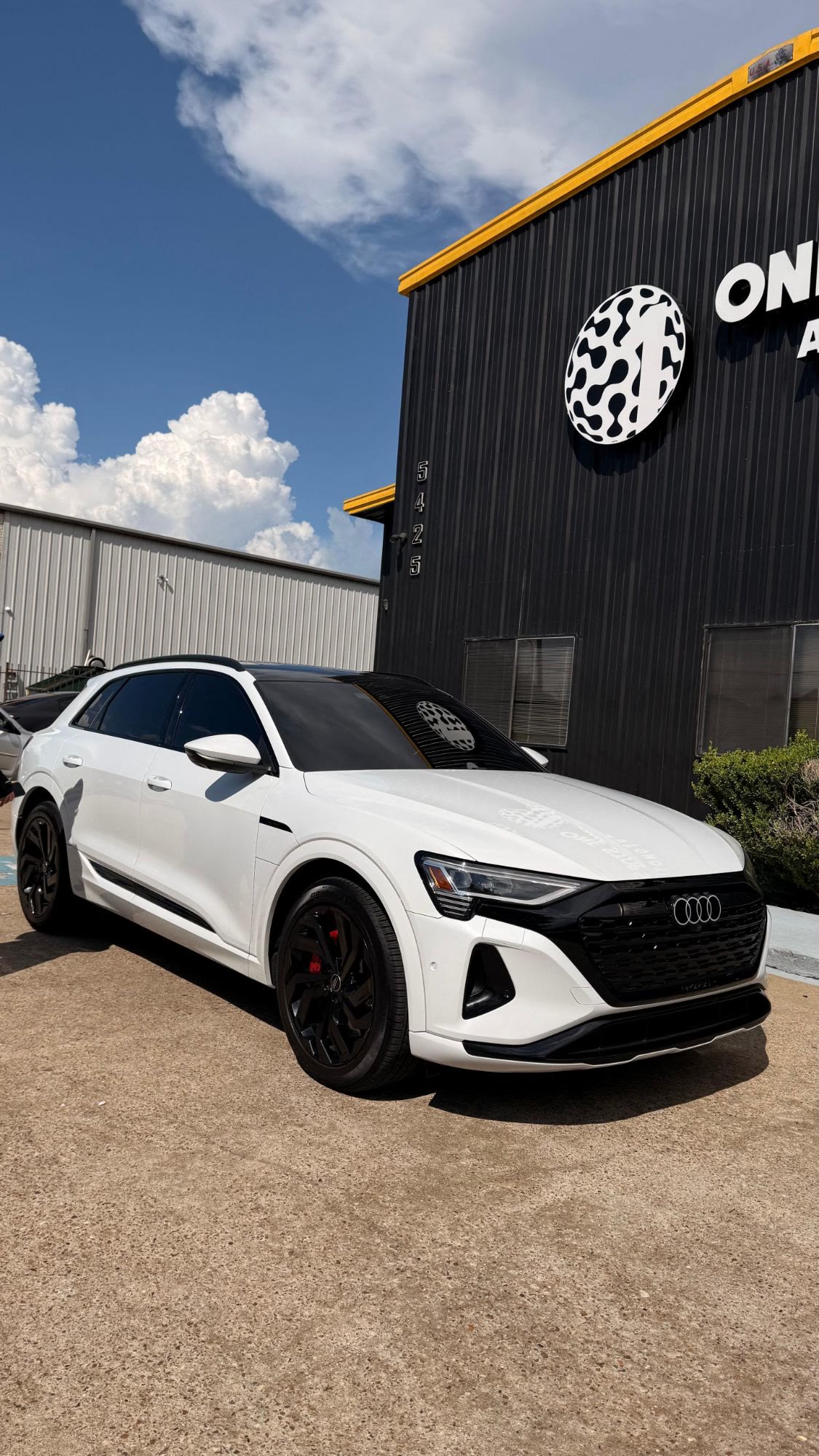 Finished white Audi outside Auto Pros Collision